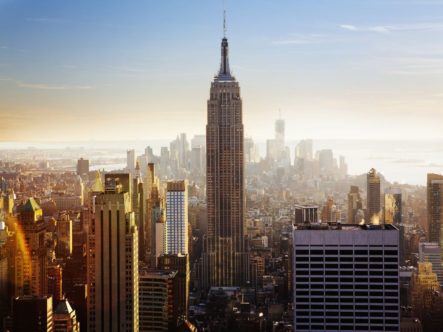 The NYC downtown cityscape, with the Empire State Building, representing renting vs buying in NYC.
