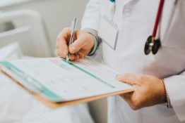 A doctor writing on a piece of paper