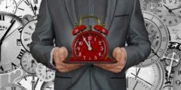 Businessman holding a clock