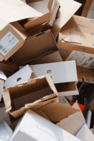 a pile of moving boxes necessary to pack for summer storage