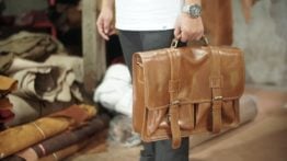 person holding a bag carrying a handbag