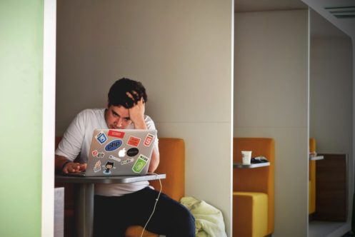 man focusing to the laptop screen