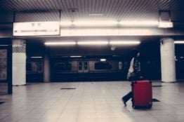 A woman carrying a suitcase, moving from Long Island.