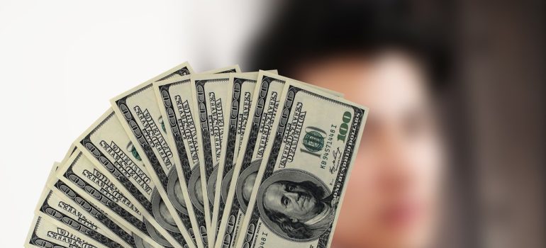 A man holding a stack of dollar bills.