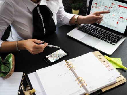 A woman with a laptop and a notebook - here's how to pick the perfect NYC realtor