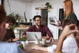 People sitting at a desk with a laptop