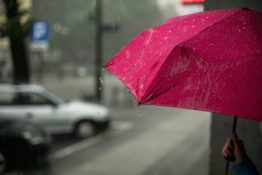 A person holding an umbrella - bad weather is another reason for postponing your move