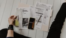 Tax papers and a calculator - your budget is among the best reasons for postponing your move