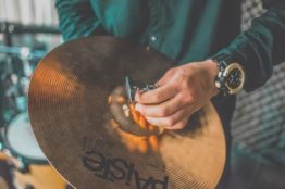 Person holding cymbal