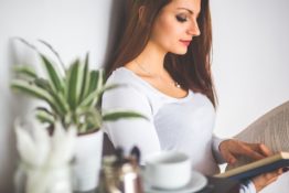 A woman reading about downsizing in Astoria