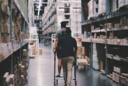 Two men working inside a storage