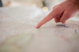 person with a finger on a map