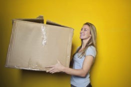 woman holding a big box A woman carrying a large moving box