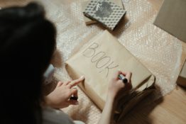 a woman labeling the package
