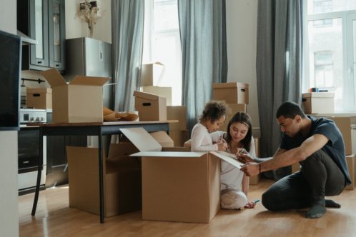 family with moving boxes planning on how to include kids in the moving process