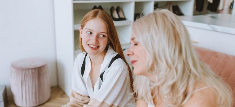 A mother and a grown up daugther talking.