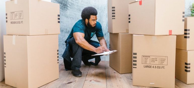 A man labeling boxes