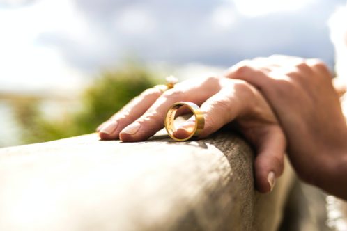 woman taking off the ring and preparing for moving out after divorce