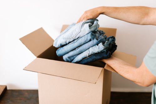 a person putting clothes in a box