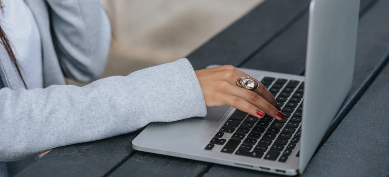 A woman typing on a laptop