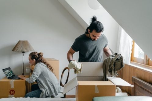two people packing their boxes with possessions you rarely use