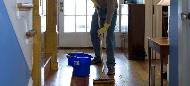 person cleaning the floor shows how you should prepare your Astoria home for a moving estimate