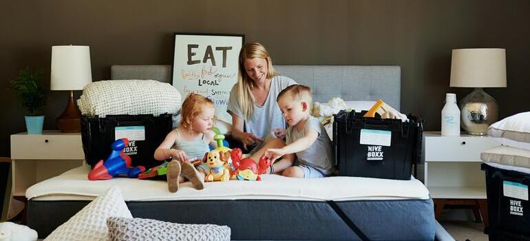 woman with two kids on the bed