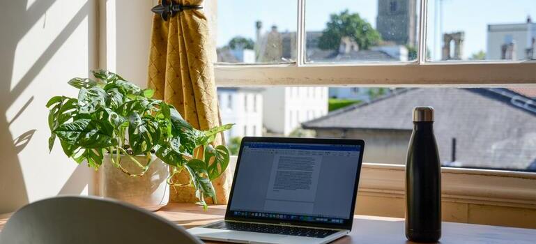 laptop next to the window