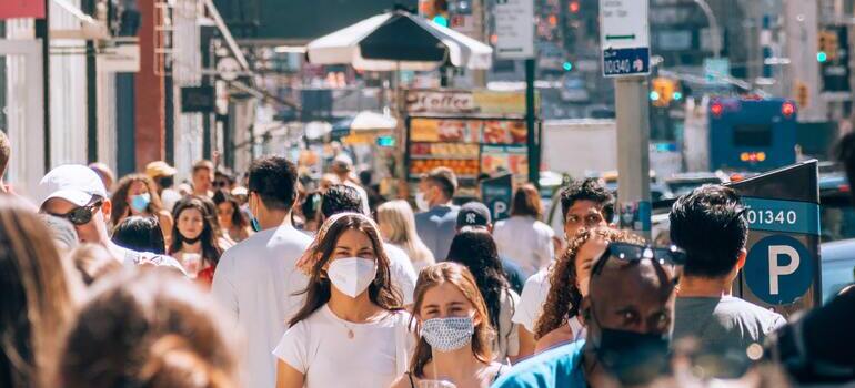 Fun facts about living in Manhattan include people walking in Manhattan