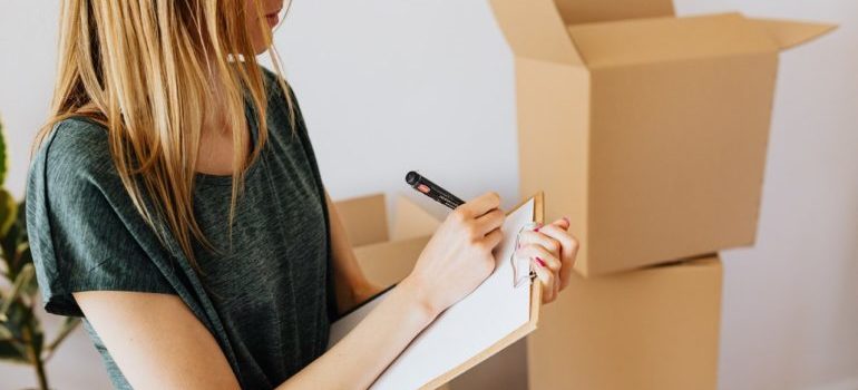 A woman creates a list and thinking about tips for relocating to Chelsey