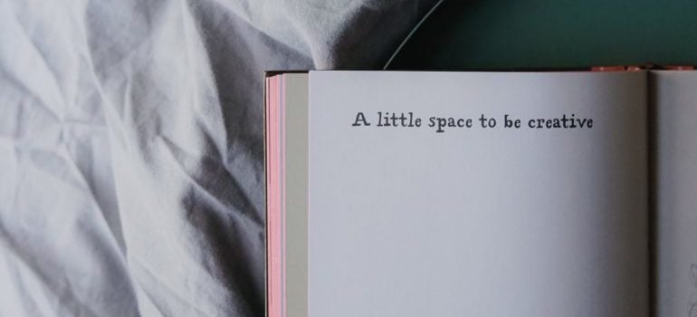 "A little space to be creative" written on a pink notebook
