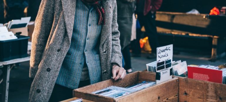 a person looking through items at Chelsea flee market 