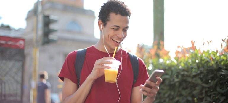 Cheerful man looking on the fone what things to do during the school holidays